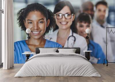 The team that saves lives. Portrait of a diverse team of doctors standing together in a hospital. Wall mural