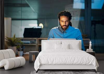 To stay productive you need to stay persistent. Cropped shot of a young designer working late on a laptop in an office. Wall mural