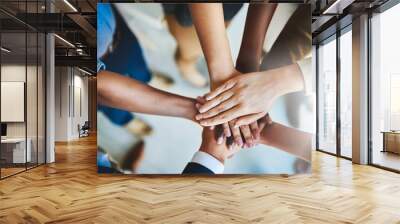 Together we can do great things. Cropped shot of a group of businesspeople piling their hands on top of each other. Wall mural