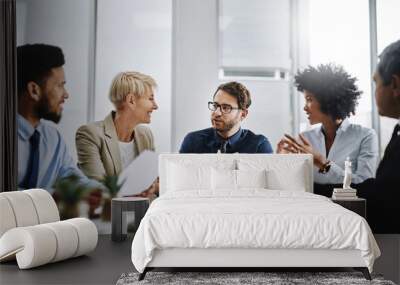 We can finish this if we work together. Shot of a group of businesspeople sitting together in a meeting. Wall mural