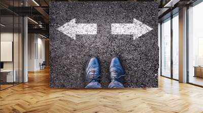 feet and two arrows painted on an asphalt road, choice and division, society polarization concept Wall mural