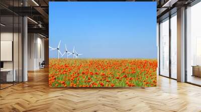 Panorama of wind turbines aligned in a poppy field, renewable energy supply header Wall mural