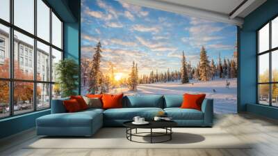 Snowy landscape at sunset, frozen pine trees covered with snow in winter in Saariselka, Lapland, Finland. Christmas and holidays background Wall mural