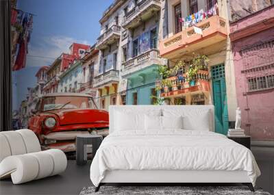 Vintage classic red american car in a colorful street of Old Havana, Cuba - carribean travel Wall mural