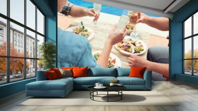 Friends celebrate at party by swimming pool Wall mural