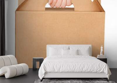 Woman hand hold blank cardboard box isolated on white background Wall mural