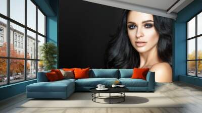 Beautiful woman portrait on black background. Glamour make up and long curly hair. Wall mural