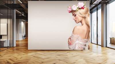 Beautiful woman portrait with long blonde hair and flowers on head. Tender bride.  Wall mural