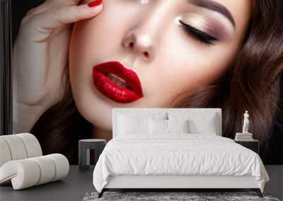 Beautiful woman portrait. Young lady posing close up on black background. Glamour make up, red lipstick, red nails.  Wall mural