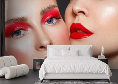 Beauty portrait of two women with red glamour make up. Red lips and red eyeshadows. Wall mural