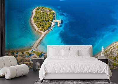 Aerial view of beutiful small island in sea bay at sunny day in summer in Murter, Croatia. Top view of transparent blue water, green trees, mountain, sandy beach, boats and yachts. Tropical landscape Wall mural