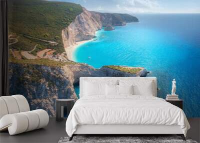 Aerial view of blue sea, mountain cape, sandy beach, sky with clouds at sunrset in summer. Porto Katsiki, Lefkada island, Greece. Beautiful top view of sea coast, rocks, azure water, green forest Wall mural