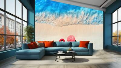 Aerial view of blue sea with waves and empty white sandy beach with red swim ring and umbrella at sunset in summer in Zanzibar, Africa. Tropical landscape with sand and azure water. Ocean. Top view Wall mural