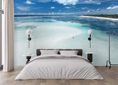 Aerial view of island during low tide, sandbank in ocean, white sandy beach, people, blue sea at sunny summer day in Zanzibar. Top view of sand spit, clear water, sky with clouds. Tropical background Wall mural