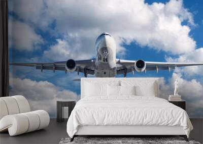 Airplane is flying in clouds at sunny day in summer. Landscape with passenger airplane, blurred blue sky. Aircraft is taking off. Business travel. Commercial plane. Transport. Private Jet Wall mural