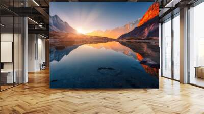 Beautiful landscape with high mountains with illuminated peaks, stones in mountain lake, reflection, blue sky and yellow sunlight in sunrise. Nepal. Amazing scene with Himalayan mountains. Himalayas Wall mural