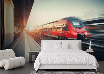 Beautiful railway station with modern red commuter train at suns Wall mural