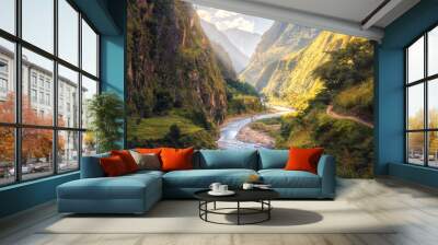 Colorful landscape with high Himalayan mountains, beautiful curving river, green forest, blue sky with clouds and yellow sunlight at sunset in summer in Nepal. Mountain valley. Travel in Himalayas Wall mural