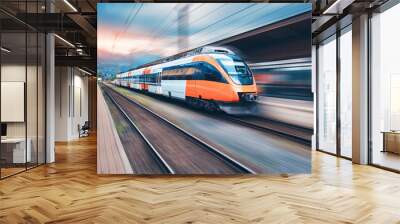 High speed orange train in motion on the railway station at sunset. Modern intercity passenger train with motion blur effect on the railway platform. Industrial. Railroad in Europe. Transport Wall mural