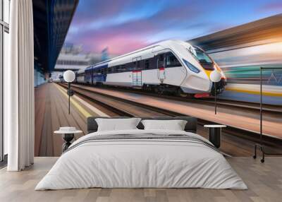 High speed train in motion on the railway station at sunset. Modern intercity passenger train with motion blur effect on the railway platform. Industrial. Railroad in Europe. Commercial transportation Wall mural