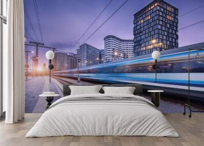 High speed train in motion on the railway station at sunset. Moving blue modern intercity passenger train, railway platform, buildings, city lights. Railroad in Vienna, Austria. Railway transportation Wall mural