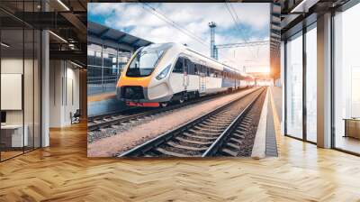 High speed train on the railway station at sunset Wall mural