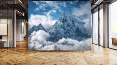 Manaslu mountain with snowy peak in clouds in sunny bright day in Nepal. Landscape with high snow covered rocks and blue cloudy sky. Beautiful nature. Fairy scenery. Aerial view of Himalayan mountains Wall mural