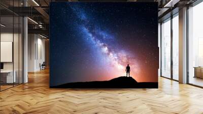 Milky Way. Night sky with stars and silhouette of a man Wall mural