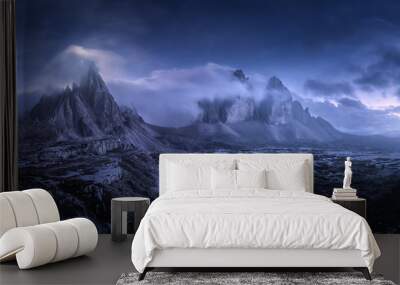 Mountains in fog at beautiful night. Summer landscape with mountain valley, stones, grass, blue sky with low clouds, stars and moon. High rocks at dusk. Tre Cime park in Dolomites, Italy. Italian alps Wall mural