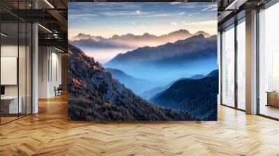 Mountains in fog at beautiful sunset in autumn in Dolomites, Italy. Landscape with alpine mountain valley, low clouds, trees on hills, village in fog, blue sky with clouds. Aerial view. Passo Giau Wall mural