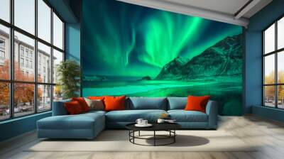 Northern lights in Lofoten islands, Norway. Green aurora borealis. Starry sky with polar lights. Night winter landscape with aurora, sea with frosty coast and sky reflection, snowy mountains. Travel Wall mural