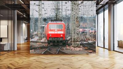 Railway station with modern red commuter train at sunset Wall mural