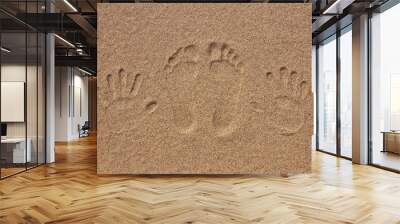 imprint of feet and hand on the sand Wall mural