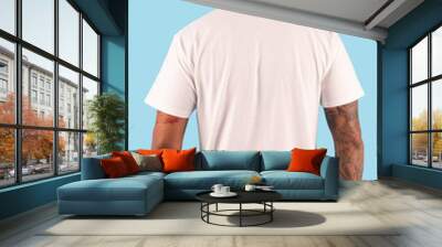 Man with white t shirt in back view side isolated on background. Hipster man with tattoo wearing white t shirt ready for your mock up template or background. Wall mural