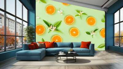  Slices of orange fruit and blossom with leaves. Wall mural