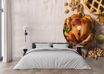 Fall thanksgiving table with roasting chicken or turkey, nuts, pie, pumkins and other food on light tablecloth Wall mural