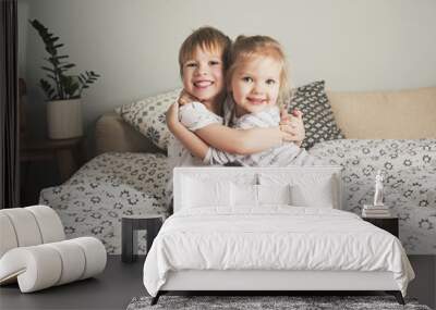 Two pretty kids embrace Wall mural