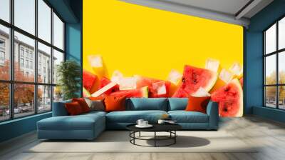 Watermelon slices with ice flat lay on yellow background Wall mural