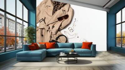 Women fashion clothes and accessories flat lay, beige trench coat with bag, glasses, denim and western boots Wall mural