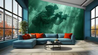 A special forces soldier dressed in camouflage and tactical equipment, wearing a helmet and night vision goggles, holds a machine gun in his hands, stands ready Wall mural