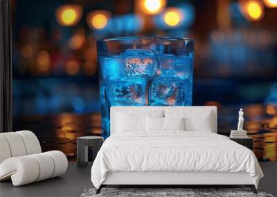 Blue alcohol cocktail with ice cubes, bar, glass Wall mural