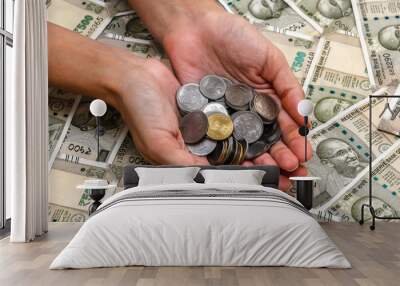 Close up view of woman's hands with indian rupees coins. 500 rupee banknotes in background. Wall mural