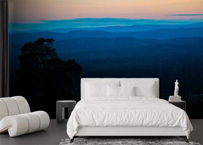 sunset behind layers of blue hills Wall mural