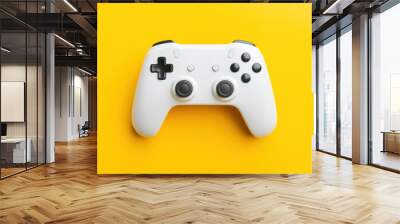 Flat lay shot of a white gamepad controller on bright yellow background. Top view. Wall mural