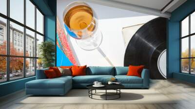 vinyl record and glass of wine on white table Wall mural