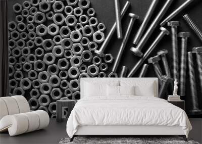 Metal nuts and bolts close up on black background Wall mural