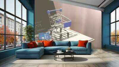 Online shopping with home delivery. Shopping basket on laptop keyboard. Wall mural