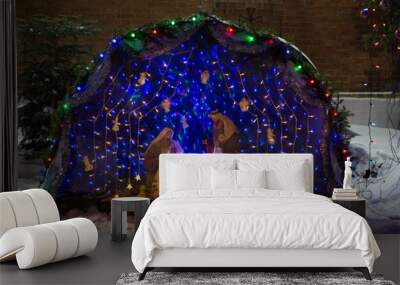 outdoor biblical scene of the birth of Christ. Traditional composition of dolls, illuminated from the inside Wall mural