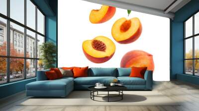 Levitating peach isolated. Composition of peaches, peach halves and slices with green leaves on a white background. Wall mural