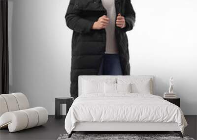 Attractive woman in a down jacket isolated on white. Wall mural